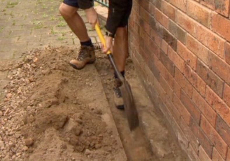 Digging a trench for a termite treatment